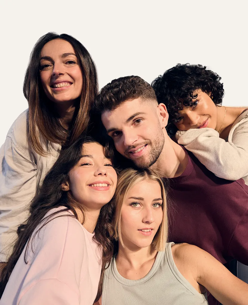 A diverse group of smiling young adults posing together, representing unity, beauty, and the inclusive spirit of the MAVALA brand.